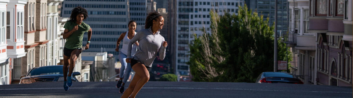 Three people jogging down the streets of San Francisco.