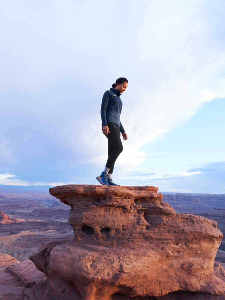 A woman standing on red rocks