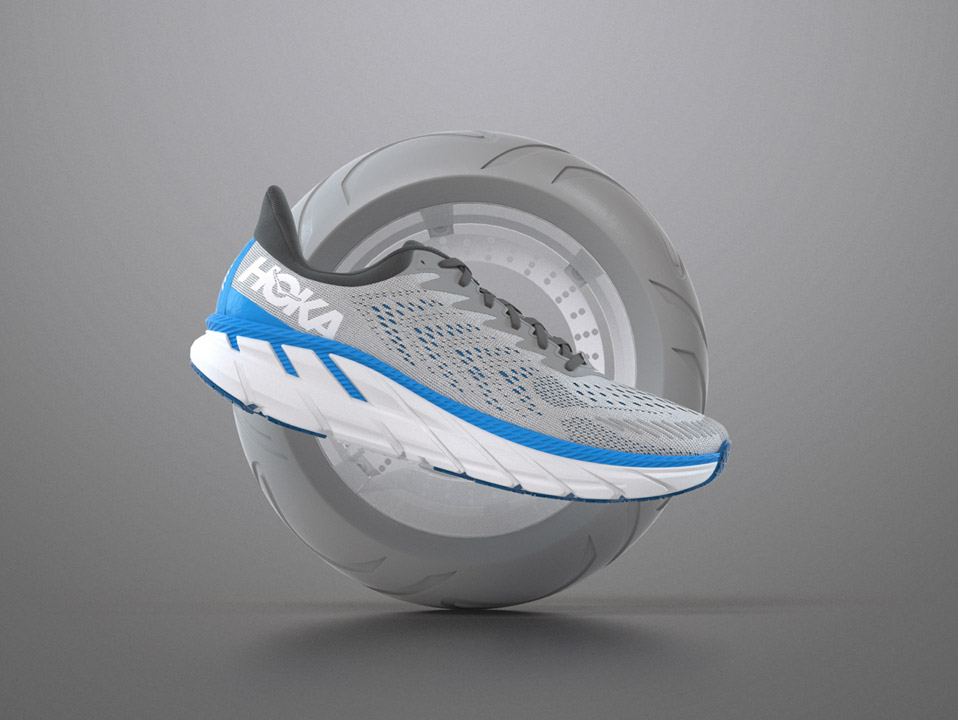 An image of a hoka shoe in front of a tire